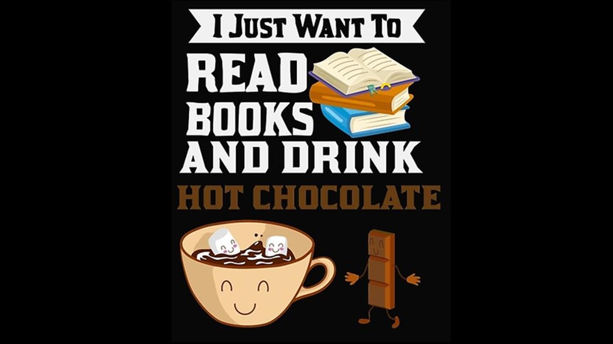 Hot chocolate with marshmallows in a mug next to some books